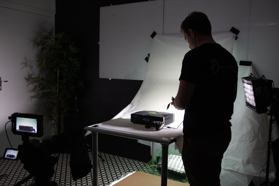 Multi-camera television studio setup with lighting rigs pointed at a presenter desk